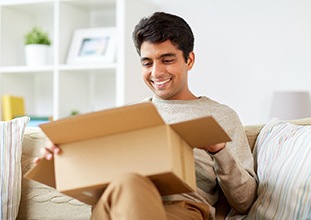 Man opening box and smiling