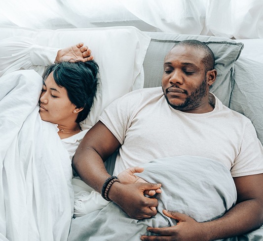 Man and partner sleeping peacefully