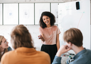 Woman smiling while giving presentation at work