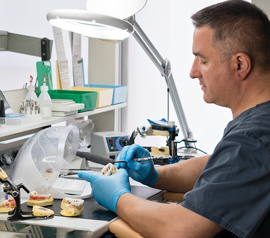 a dental technician creating a bridge