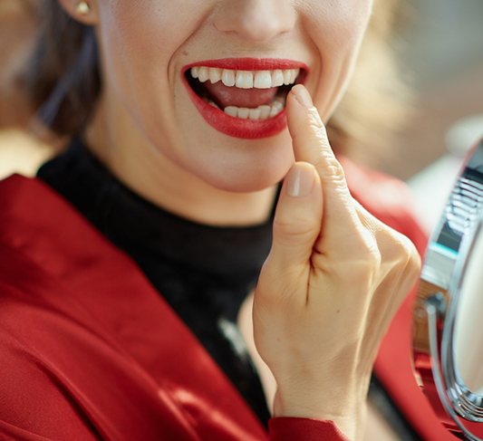 Woman smiling with dental crown in North Raleigh