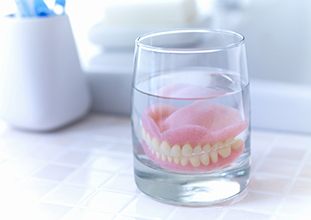 Dentures in North Raleigh soaking in solution