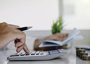 Man calculating cost of dentures in North Raleigh