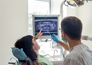 emergency dentist in Raleigh showing a patient their dental X-rays 