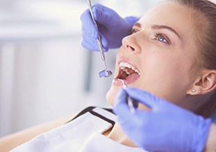 Woman visiting Raleigh emergency dentist for a checkup