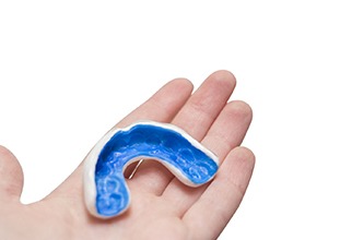 Person holding a mouthguard