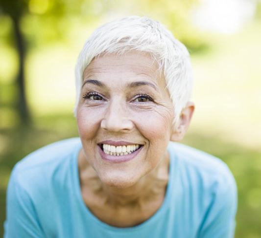 woman with dental implants in Raleigh showing off her pearly whites 