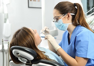 dental hygienist cleaning a patient’s teeth 