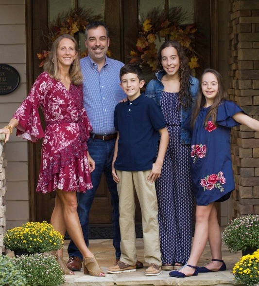 Raleigh dentist smiling outdoors with his family