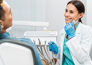 Smiling Raleigh dentist looking at patient