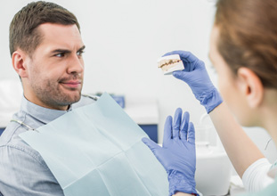 Patient in North Raleigh talking to dentist about scaling & root planing