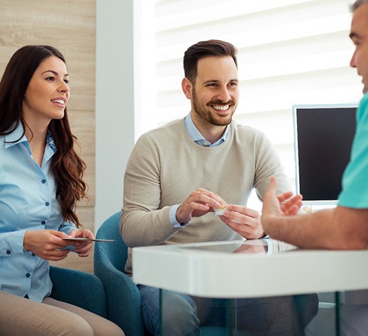 Dentist discusses matters with patients