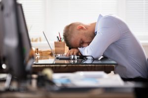 A man asleep at his job.