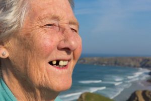 An older woman with missing teeth.