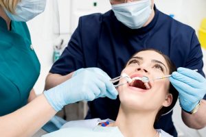 a woman getting her teeth cleaned