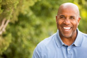 older man smiling with dental implants