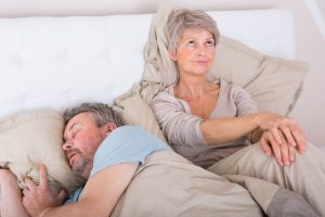 older woman angry at man snoring