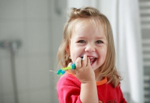 little girl holding her toothbrush