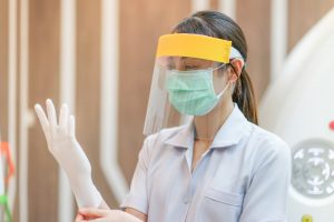 Raleigh dentist wears PPE in preparation for appointment in COVID-19