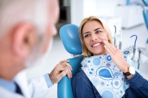 a patient experiencing dental implant sensitivity