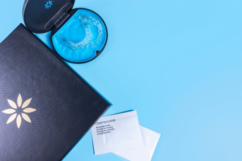 An Invisalign kit displayed on a blue tablecloth