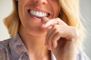 Woman putting on her Invisalign